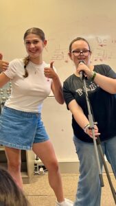 Georgia singing with a student in a singing workshop