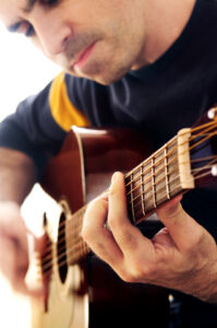 Music lessons for adults - man playing guitar
